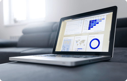 Laptop displaying a dashboard with charts and graphs